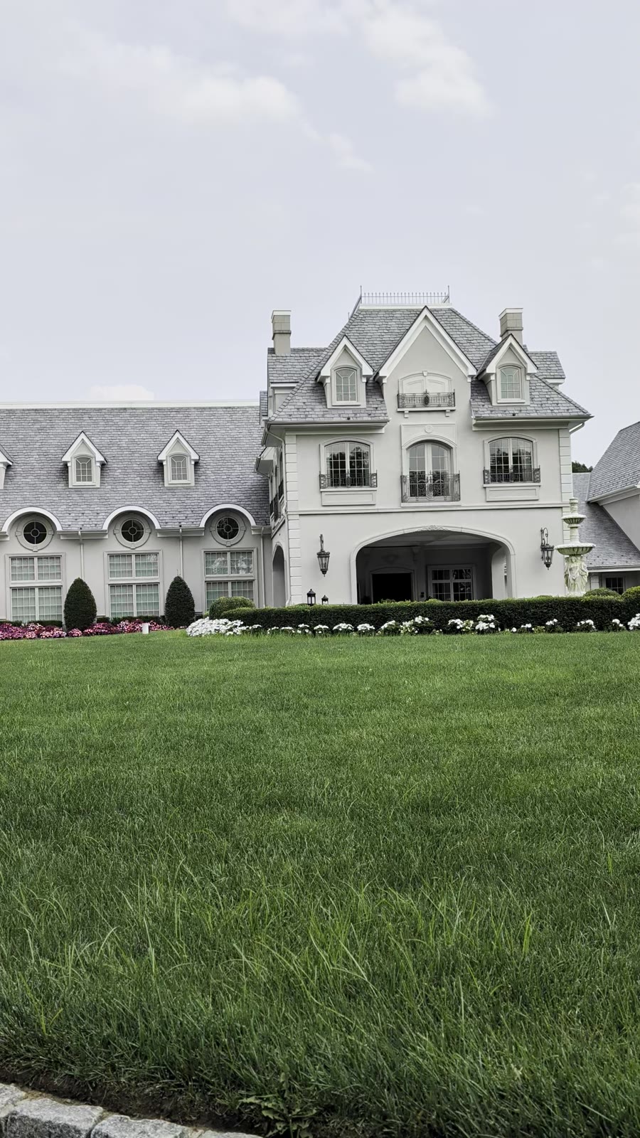 The French-style facade of Park Chateau Estate and Gardens over its lawn